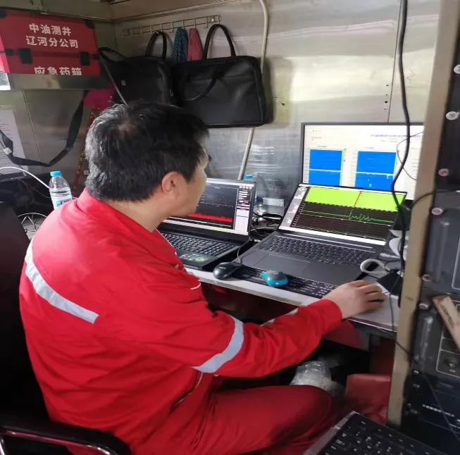 Field engineer reviewing downhole optical sensing data