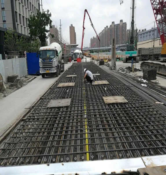 Workers installing reinforcement and sensing lines in a metro construction site